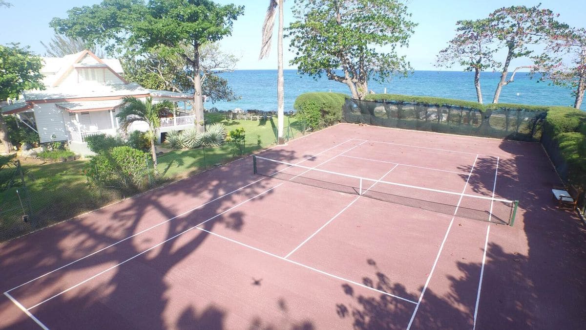 The estate's tennis court beside the sea, seen from above