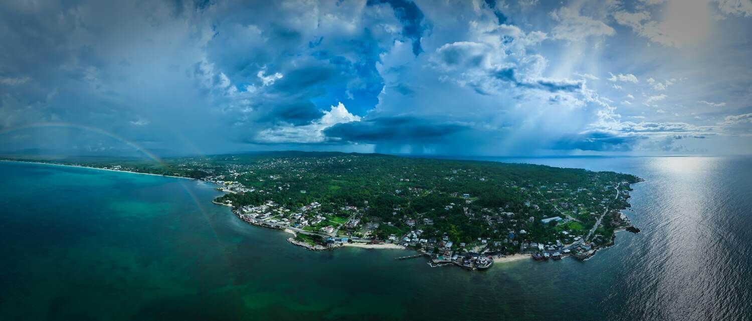 Aerial panorama of Negril's coastline under a dramatic sky