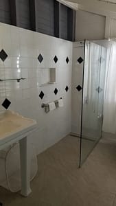Walk in shower in grey bedroom.